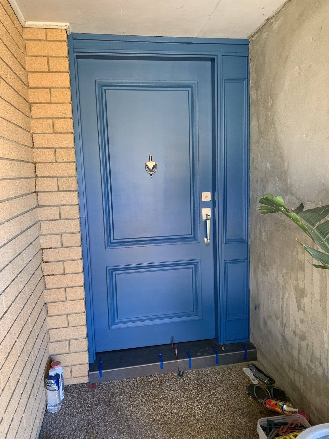 New blue panelled front entry door hung with an entry knob set and deadlock by Loel Homes