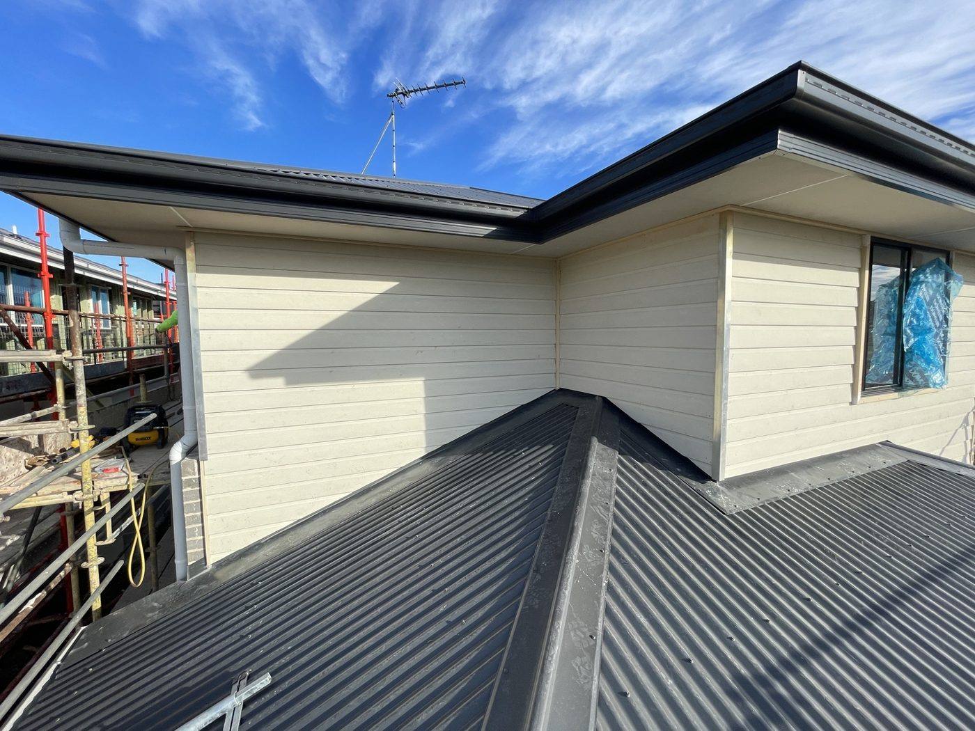 Completed weatherboard-clad upper level with charcoal fascia over the metal roof, double-storey home by Loel Homes