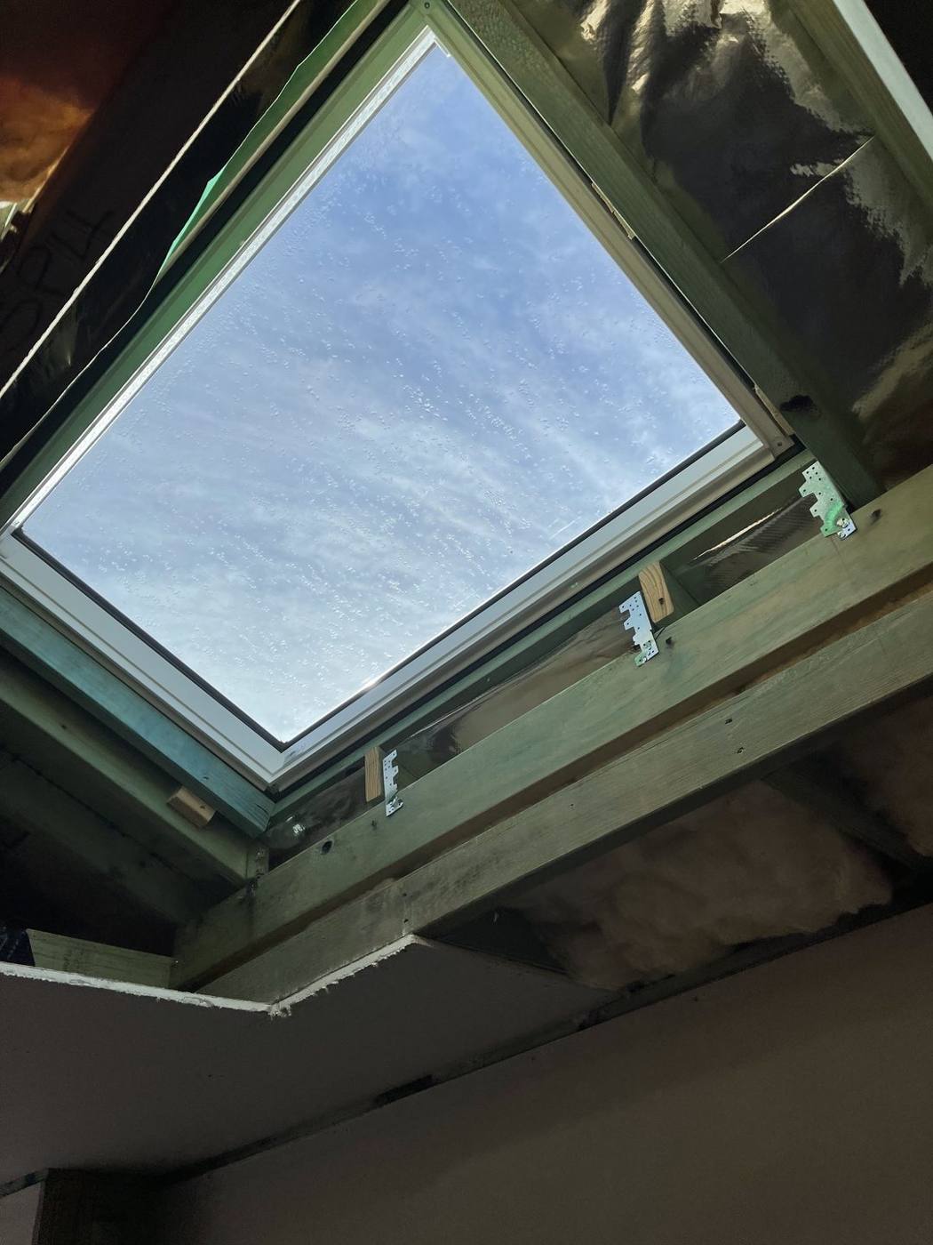 Timber lightwell shaft framed down from the new skylight, heritage terrace carpentry by Loel Homes