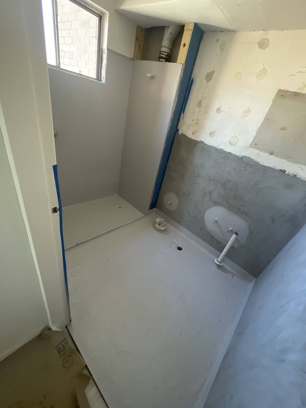Bathroom stripped back and waterproofed with screeded floor and plumbing rough-ins during renovation, Top Ryde by Loel Homes