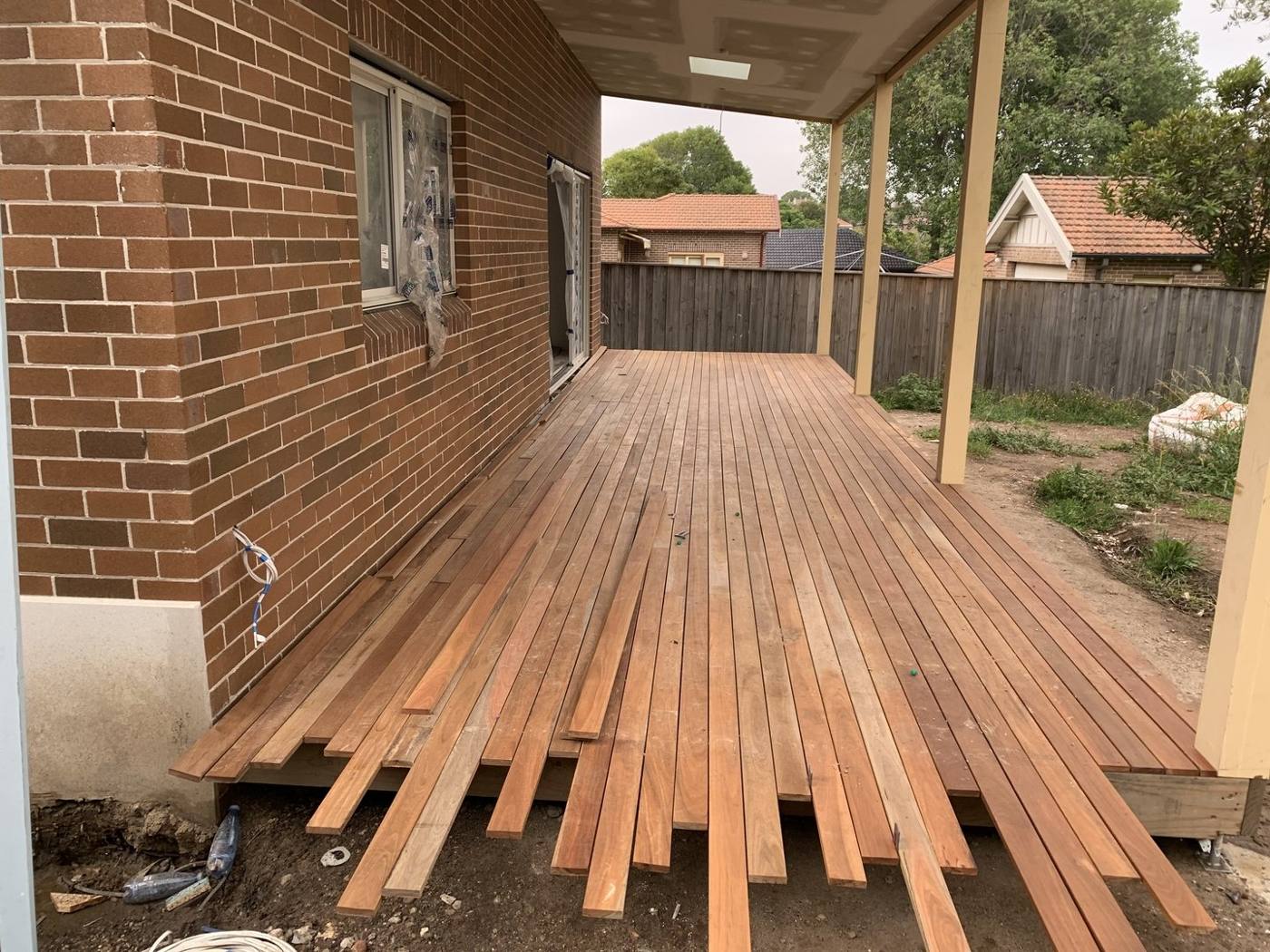 Hardwood decking boards being laid over the subframe by Loel Homes